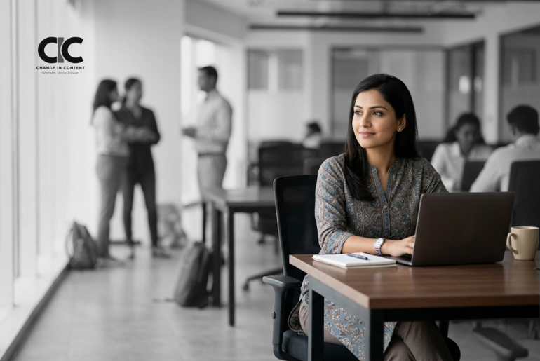 A confident Indian woman sitting in an office workspace, representing childfree women in Indian workplaces and the need for inclusive workplace culture.