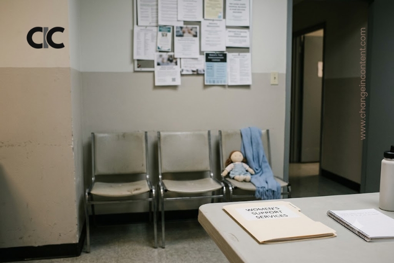 An empty humanitarian support room with chairs, a folder and a child’s toy, representing aid cuts affecting women and girls in crisis settings.