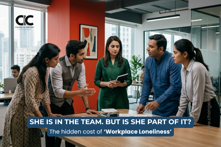 A woman stands slightly outside an active workplace discussion, illustrating how employees can feel lonely even while surrounded by colleagues.