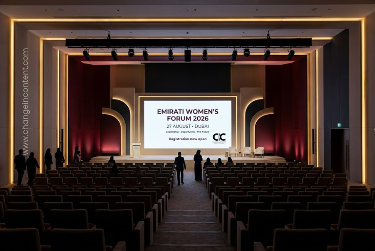 A contemporary Dubai conference venue prepares for the Emirati Women’s Forum 2026, with a stage screen showing the 27 August event date.