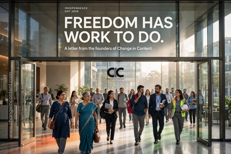 Indian professionals of different ages enter a modern workplace through open glass doors illuminated with subtle tricolour light, representing freedom, opportunity and the unfinished work of workplace equality.